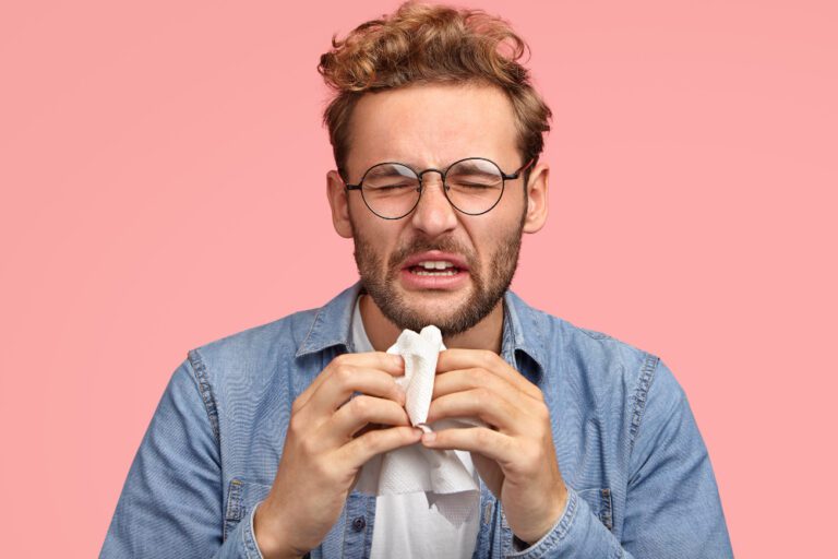 portrait-allergic-male-sneezes-all-time-rubs-nose-with-handkerchief-has-sick-look-suffers-from-cold-has-displeased-facial-exression-wears-denim-shirt-isolated-pink-people-disease-concept (1)