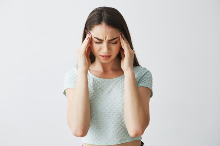 young-beautiful-brunette-girl-frowning-touching-temples-headache-isolated-white-background