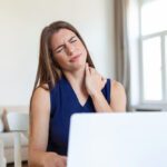 young-businesswoman-suffering-from-neckache-massaging-her-neck-while-sitting-her-working-place-home-office