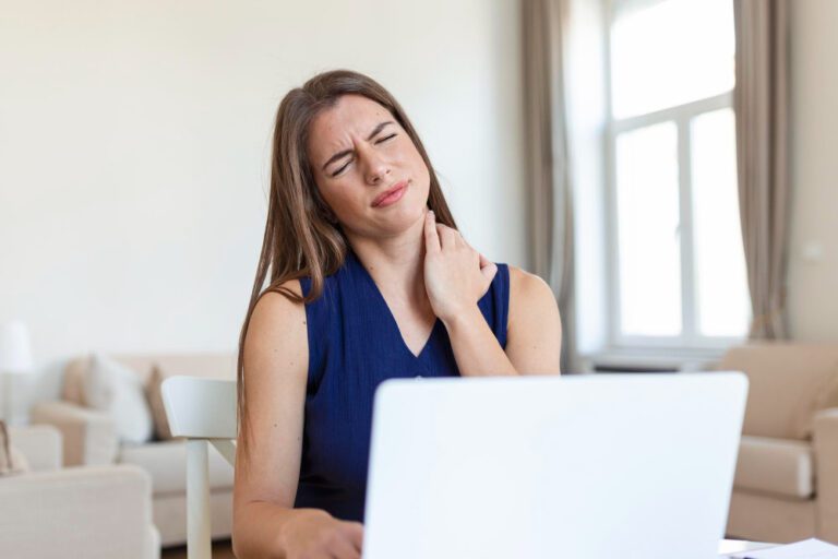 young-businesswoman-suffering-from-neckache-massaging-her-neck-while-sitting-her-working-place-home-office